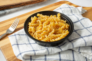 A view of cooked gluten-free rotini pasta in a bowl.