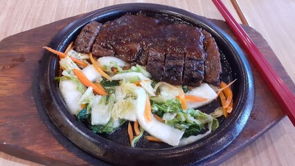 Beef steak with a side dish of grilled vegetables