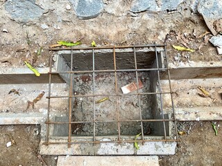 Close up iron frame installed on the drainage channel section, as a drainage cover. The process of...