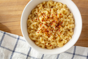 A top down view of a bowl of cooked small elbow macaroni.