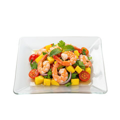 Fresh shrimp and mango salad served on a white plate with vibrant vegetables