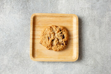 A top down view of an oatmeal raisin cookie, on a plate.