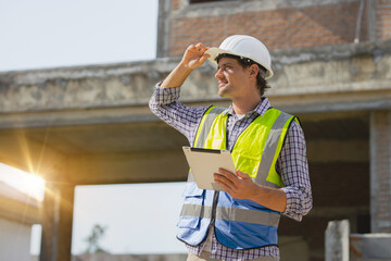 Portrait of handsome successful architect standing with arms crossed in building in construction process in site home.