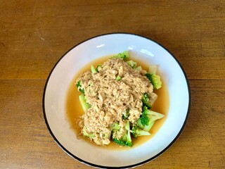 Close up Stir Fried Broccoli or Ca Broccoli on the plate with scrambled egg on the top. Healthy and delicious food for diet. High protein and fiber for vegan