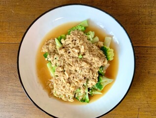 Close up Stir Fried Broccoli or Ca Broccoli on the plate with scrambled egg on the top. Healthy and delicious food for diet. High protein and fiber for vegan