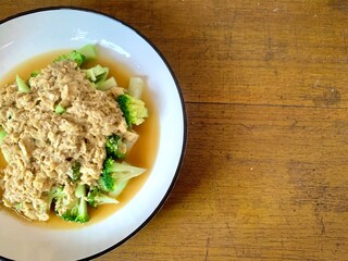 Close up Stir Fried Broccoli or Ca Broccoli on the plate with scrambled egg on the top. Healthy and delicious food for diet. High protein and fiber for vegan. Copy space for background