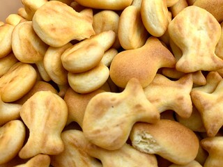 Close up small biscuits shaped like fish in a jar. This is sweet, tasty and delicious snack