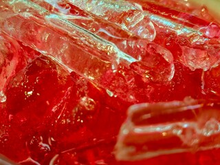Bright Red Beverage with Ice Cubes Closeup