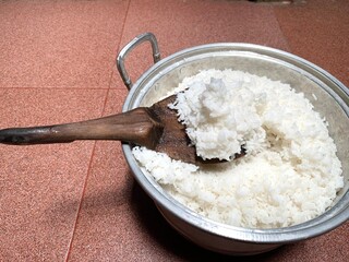 Close up a scoop of white rice in the pan. Staple food of Indonesian people
