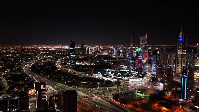 Stunning 4K aerial view of Kuwait City at night with vibrant lights, busy highways, and glowing skyscrapers. Perfect for cinematic cityscapes, tourism, commercials, or news footage.