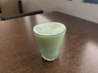 Close up a glass of Kiwi Juice on the table. Sweet, refreshing, and healthy drinks on a day