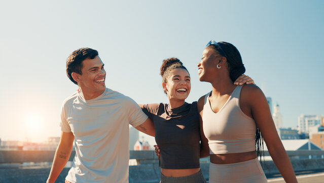 Fitness, hug and laughing with friends on bridge in city together for sports or training routine. Exercise, funny and walking with group of people outdoor in urban town for cardio or marathon