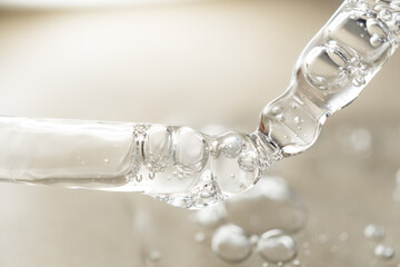 samples serum tests glass pipettes with drops of serum on a light beige background