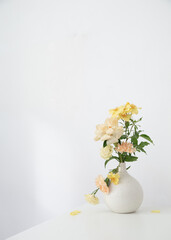 beautiful bouquet in white vase in white interior