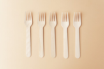 Set of wooden forks  flat lay on pastel background