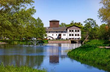 Obraz premium Medieval water mill and the pond. Historic district Oliwa in Gdansk