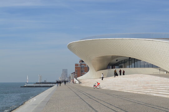 MAAT museum in Lisbon, Portugal, photographed on December 10, 2019. Editorial image showcasing modern architecture, riverfront promenade, and visitors in a cultural urban setting.