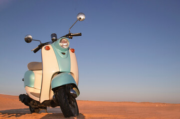 Lonely blue scooter rests under a golden Namibian sunset. A poetic blend of nostalgia, stillness,...