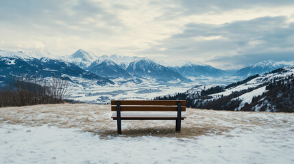 Lone Wooden Bench on Snowy Hilltop with Panoramic Mountain View