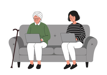 Two People Using Laptops on a Couch