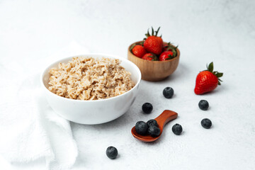 Homemade oatmeal bowl with strawberries and blueberries