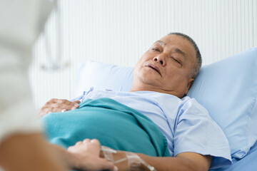 Obraz premium Doctor touching hands to encouragement mental of elderly patient after surgery at bed in hospital.