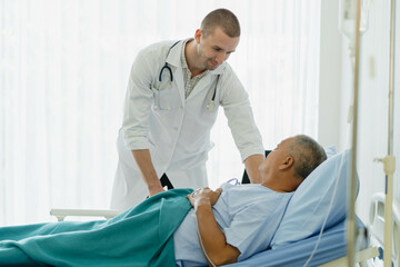 Doctor touching hands to encouragement mental of elderly patient after surgery at bed in hospital.