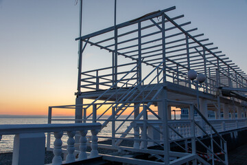 A pier with a white structure and a railing
