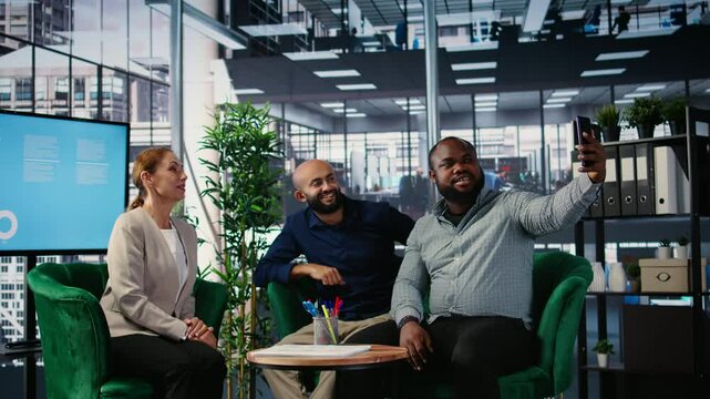 Multiethnic business people seal their partnership with a picture on social media, reaching a verbal agreement for a new international collaboration. CEOs taking photos on media platforms. Camera A.