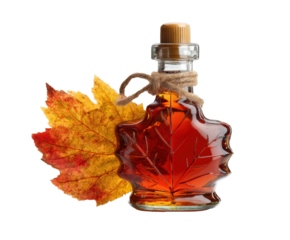 Maple syrup in glass container with autumn leaf decoration on a transparent background, cut out