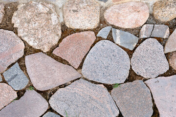 a fragment of a road laid out of stones