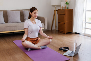 asian woman, yoga and video with laptop on floor in home, health and breathing exercise for online...