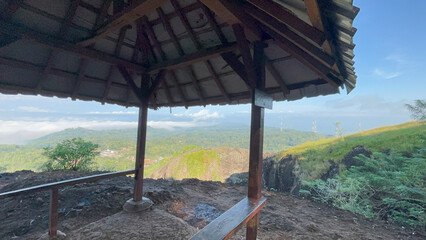 Scenic Mountaintop Gazebo Overlooking Misty Valley and Lush Greenery
