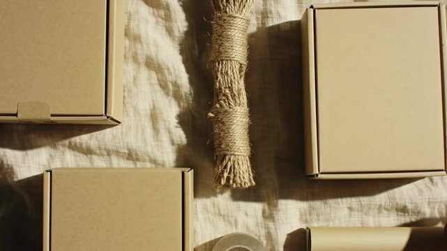 A flat lay of rustic packaging materials on a textured surface.