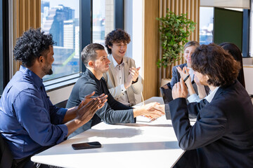 Team of diversity business people having agreement and handshake deal over new strategic strategy project on investment real estate with recognition and applause from other colleagues for partnership