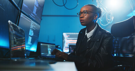 Black woman, reading and coding on computer at night for programming, cyber attack and online...