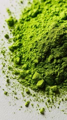 Obraz premium Macro shot of matcha powder swirling in air with vibrant green hues on white background