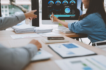 Business people analyzing financial charts and graphs on computer screen