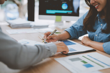 Business people analyzing financial charts and graphs in office
