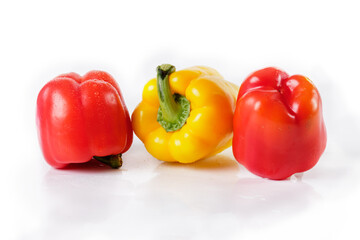 Red and yellow pepper on white, close-up
