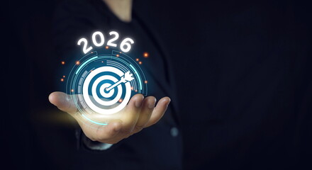 Businessman holding goal icon from success year 2026..Development to business success and...