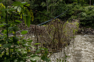 Broken hanging bridge over Huallaga river in Honolulo village near Tingo Maria, Peru