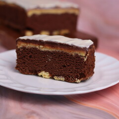 Kaasstengels or often called Cheese Shortbread in the photo with a wooden coaster and white plate. Cheese Shortbread pieces in the photo with a close up and a 45 degree angle