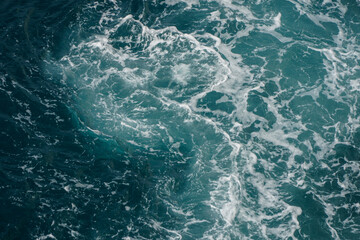 Dynamic Ocean Waves Creating Abstract Patterns in Blue and Teal Water Surface