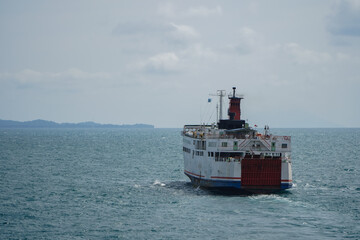 Ferry Boat Navigating Through Open Ocean Waters Under Cloudy Sky