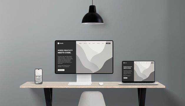 Responsive website layout shown in multiple screen formats on office desk, representing cross-device compatibility for professional web design studios