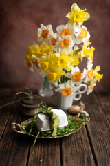 Easter Still Life with Daffodils and wax candle Eggs