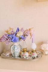 Elegant floral arrangement with antique oil lamps and pastel colors