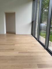 Fototapeta premium Empty room with panoramic windows and wooden floor