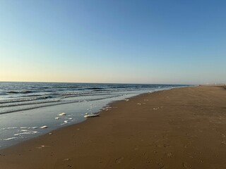 Wavy sea and shore under beautiful sky